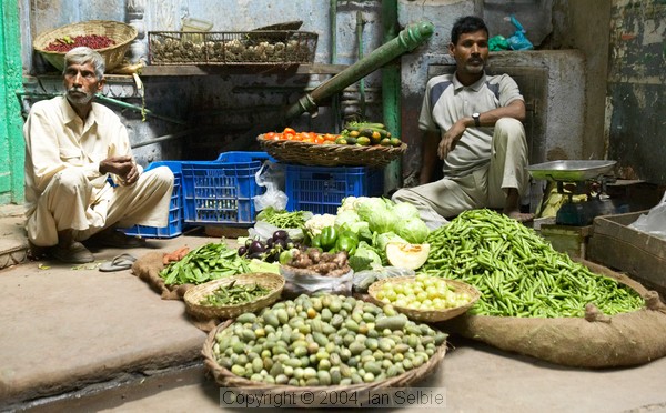 Two men selling vegetables in a side alley, Old Delhi