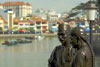 Bronzes of the River Merchants (by Aw Tee Hong) looking over the Singapore river