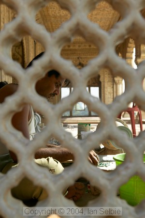 Workman seen through the lattice Diwan-i-Khas at the Red Fort, Delhi