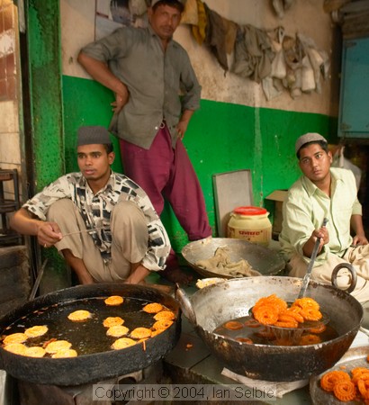 Preparing food just before break-fast in the street market near the Tomb of Nizammudin, Delhi