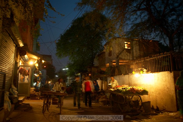 Nizammudin district, Delhi.  Almost dark and the night vendors are already about.