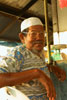Uncle sitting watching the coconut man