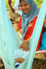 Malay lady rocking one of her twins