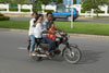 Is the child steering the motorcycle?
