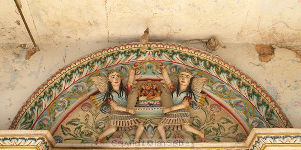 Angels above a door lintel in old Varanasi